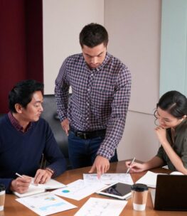 three-colleagues-discussing-business-report-examining-statistical-data